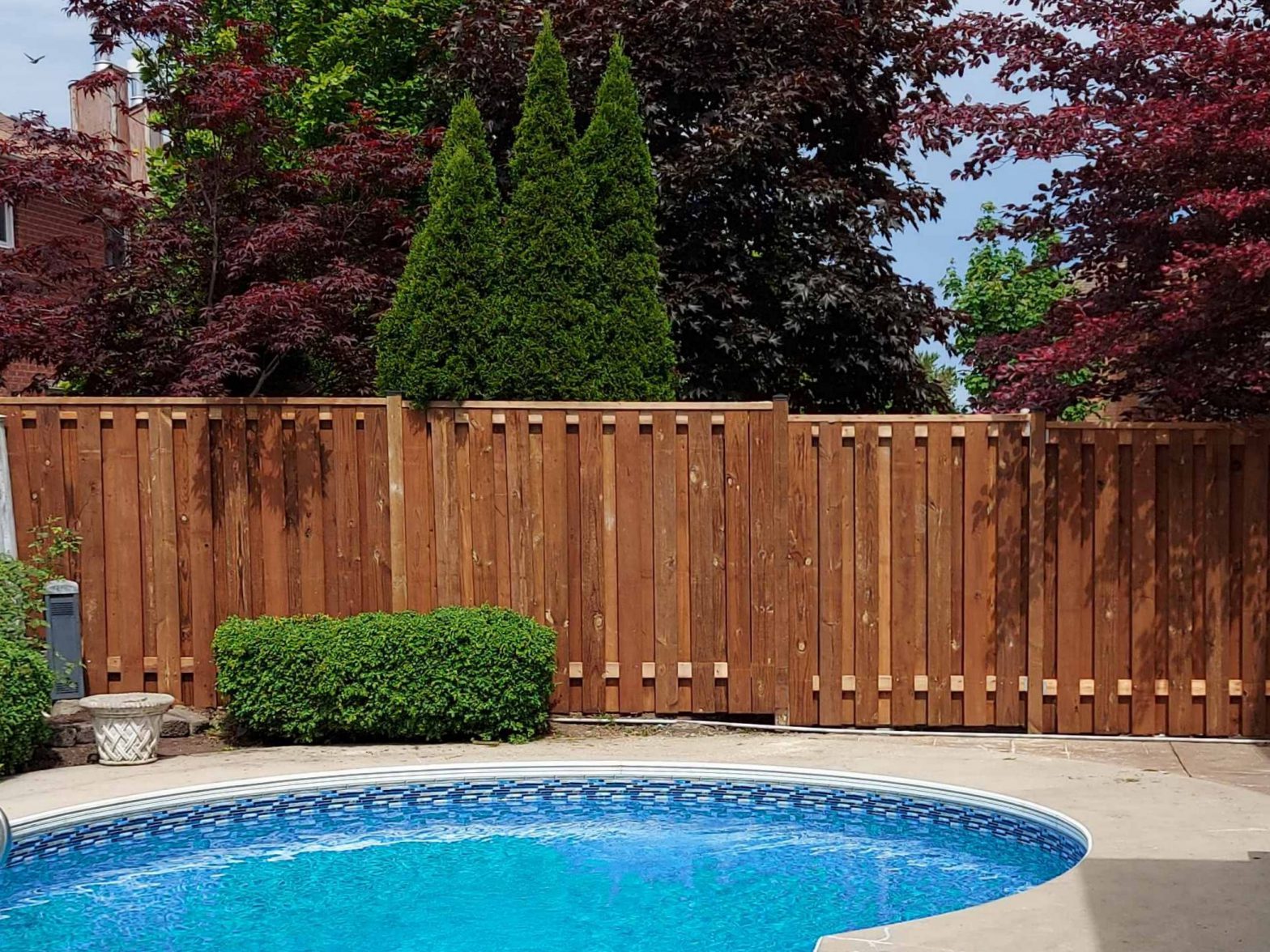 Photo of a privacy wood fence around a pool